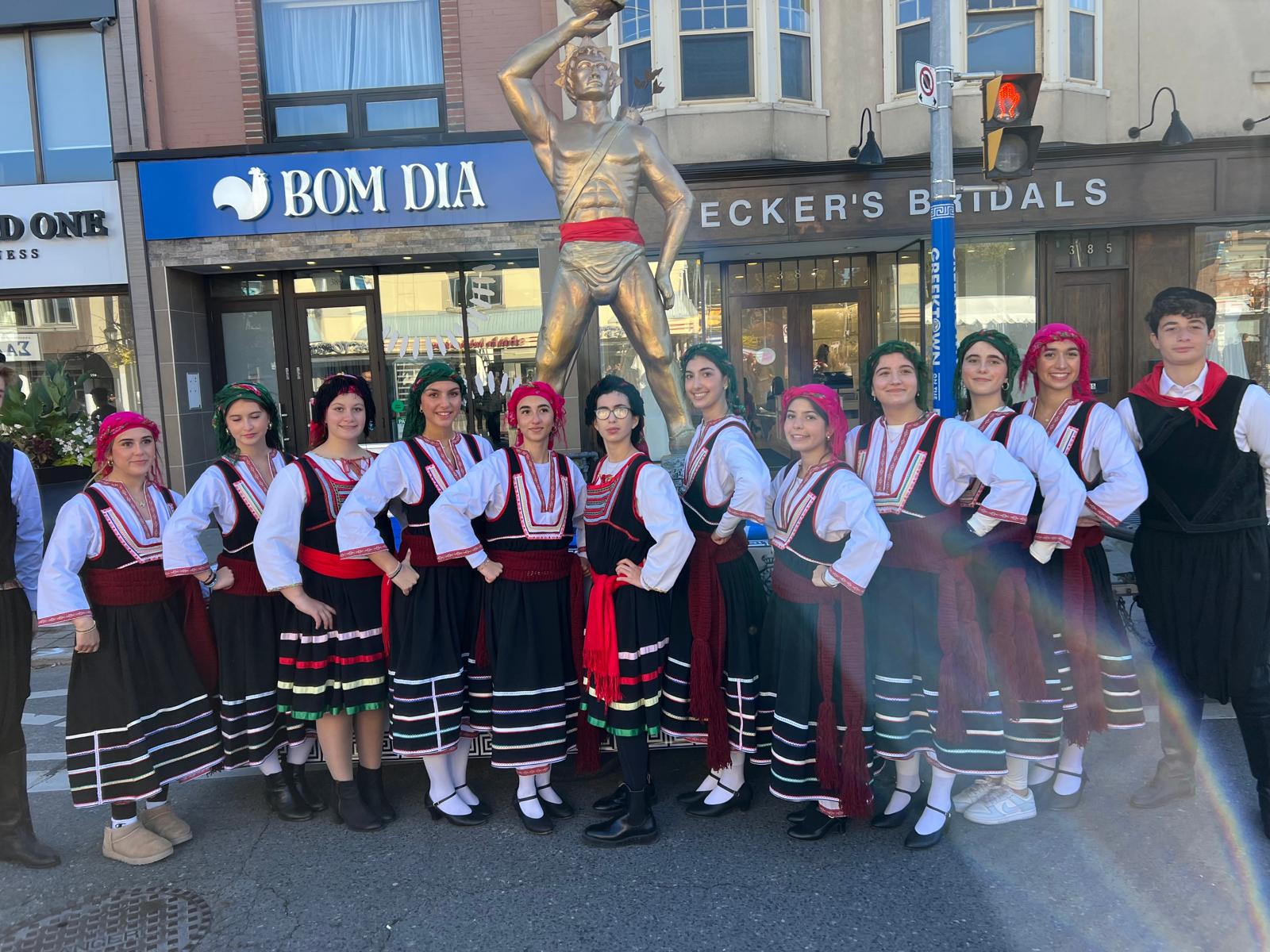 Rhodian Society youth dance group in traditional Greek costumes at a community performance
